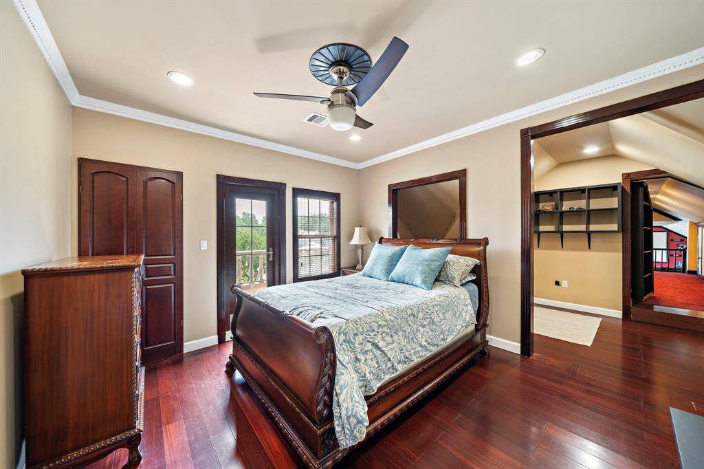 This bedroom has an additional flex space and the hallway that leads to the media/game room is just to the right. There is balcony access thru the glass door.