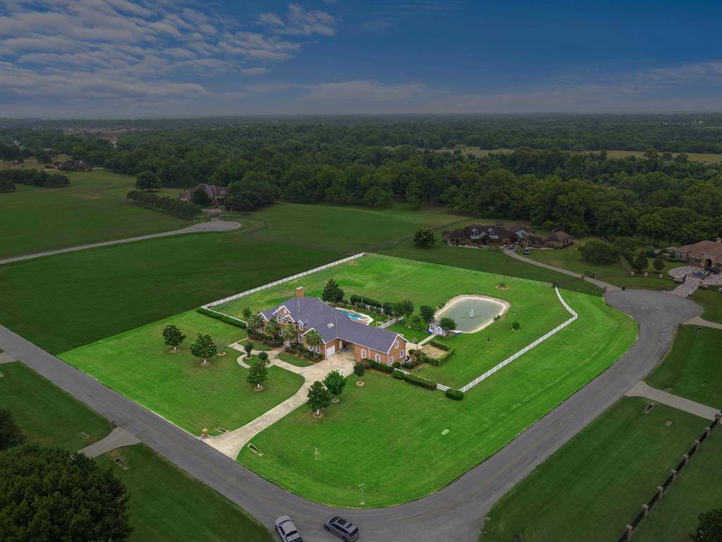 The full lot with an area for horses and a pond.