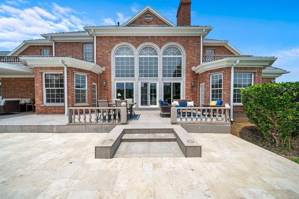 Concrete and travertine decking around the pool and patio areas.
