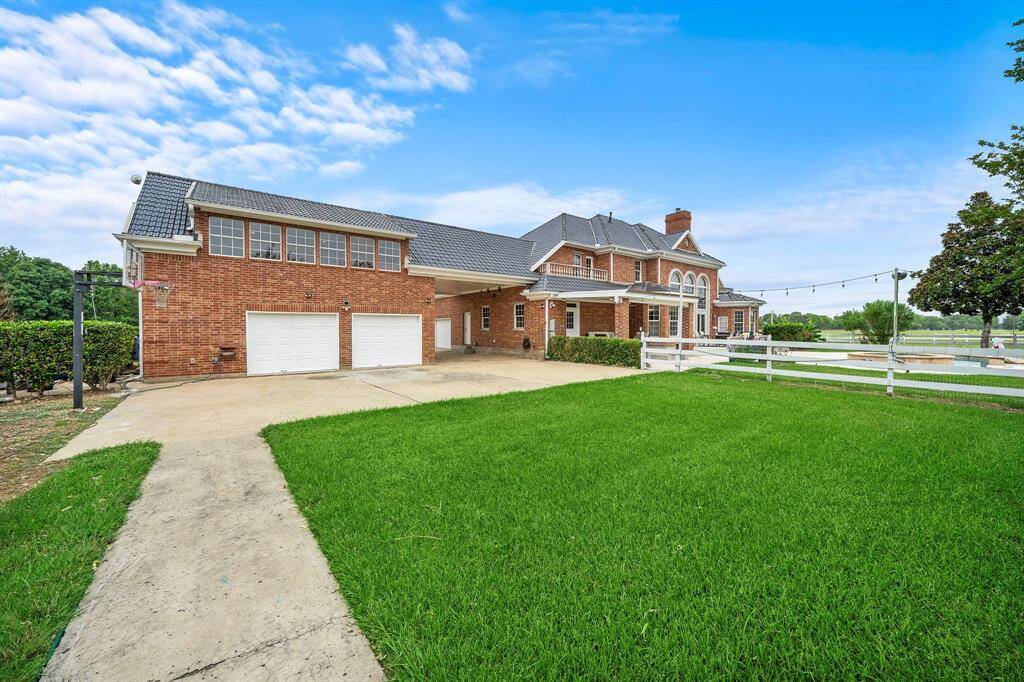 The back of the oversized garage has double doors and lots of space to play basketball.