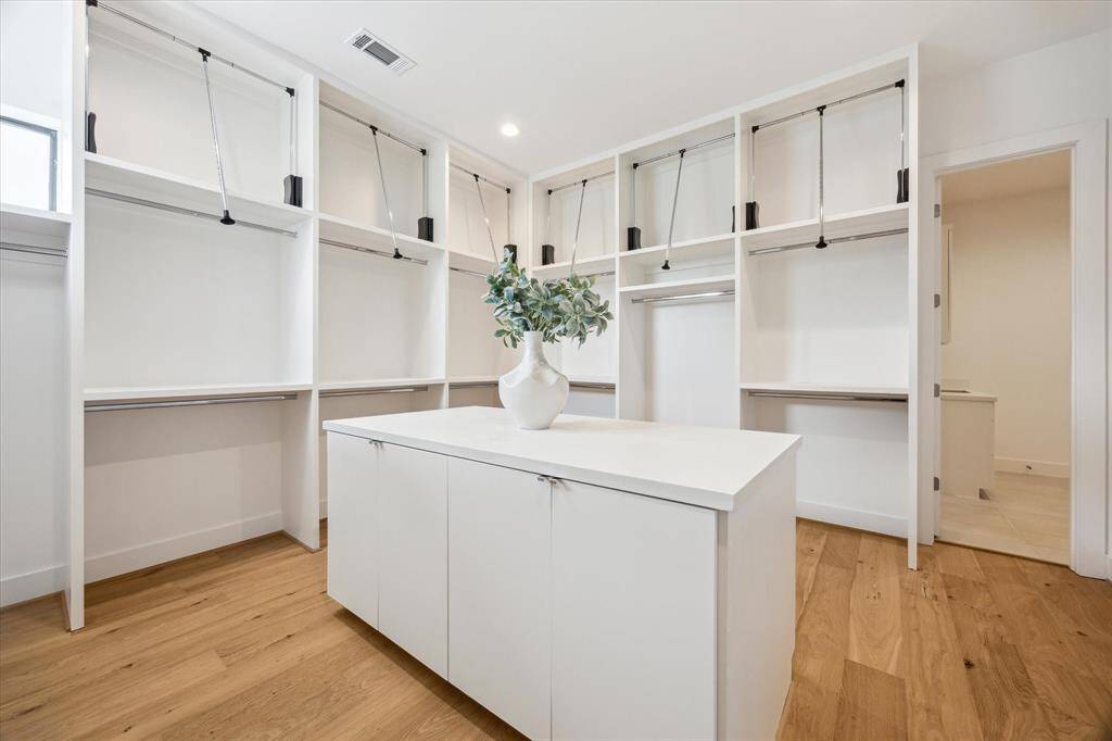 Custom primary closet with easy access to utility room