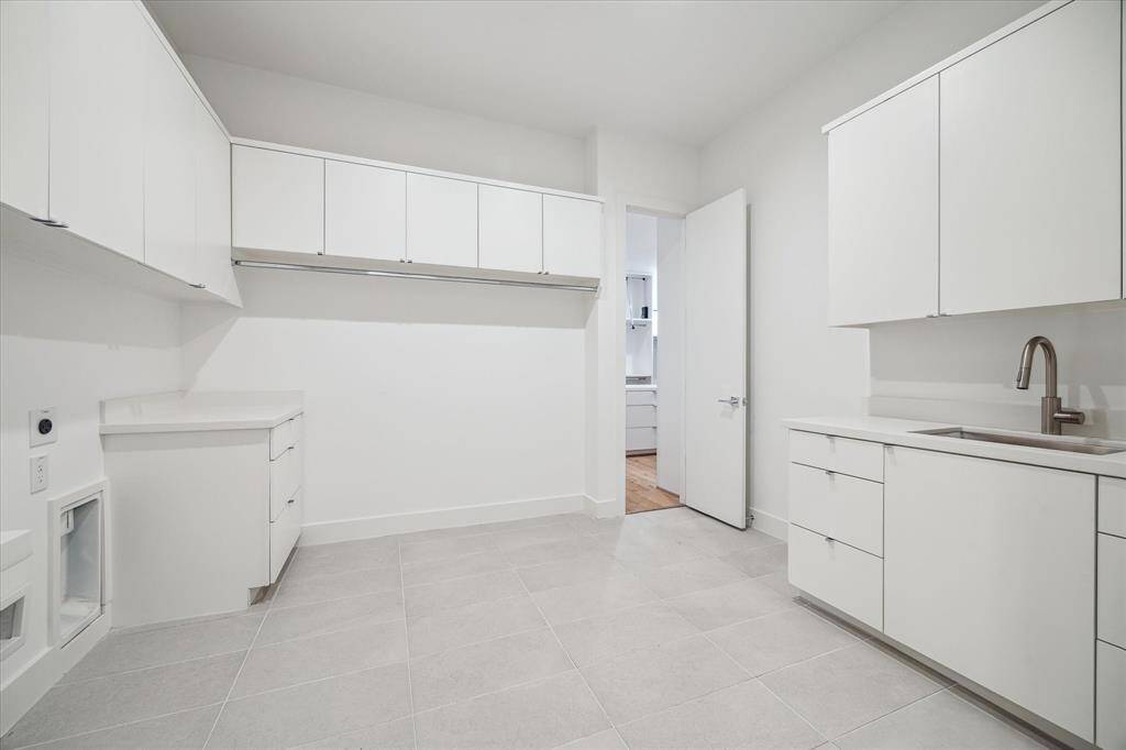 Large utility room with plenty of storage and sink