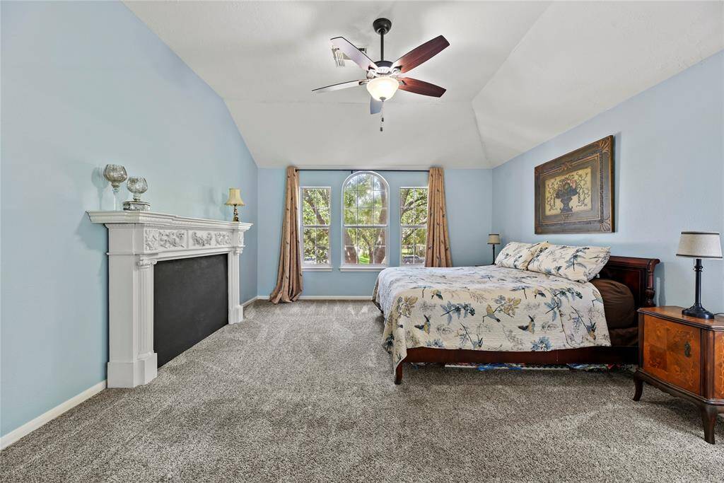 High ceilings, soft carpet, and ample windows provide the primary bedroom with a sense of gratifying bliss. Overly sized, this leisurely space accommodates large furniture and a wide range of styles.