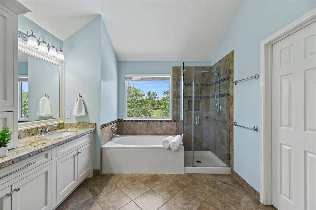 Come home to a glass of wine and a hot aromatherapy bubble bath in your enormous soaking tub. Afterward, easily rinse off the extra bubbles in the separate and spa-like glass enclosed shower.