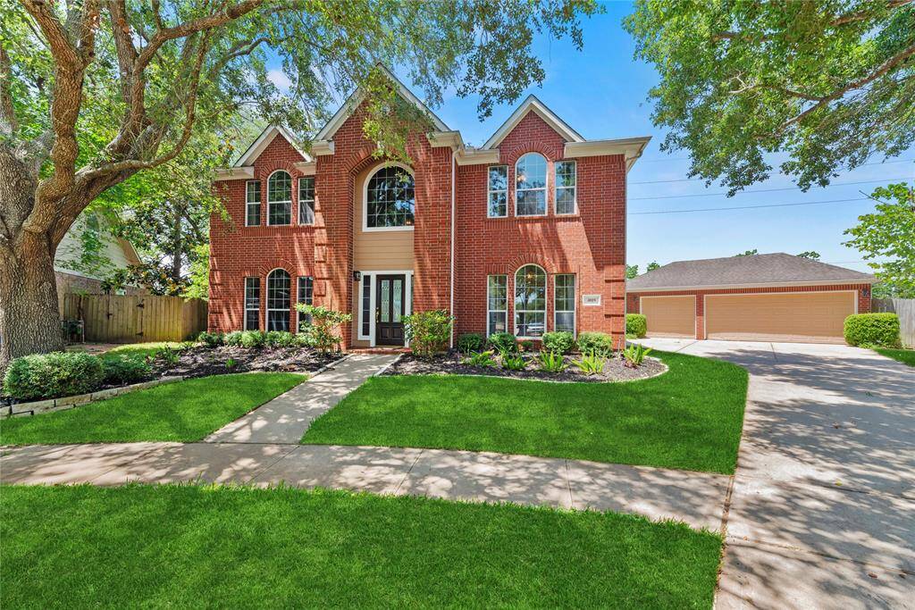 Finely crafted, the elegantly appointed brickwork entices the senses, while the charming stone-bordered flower beds add color and texture to the exterior.