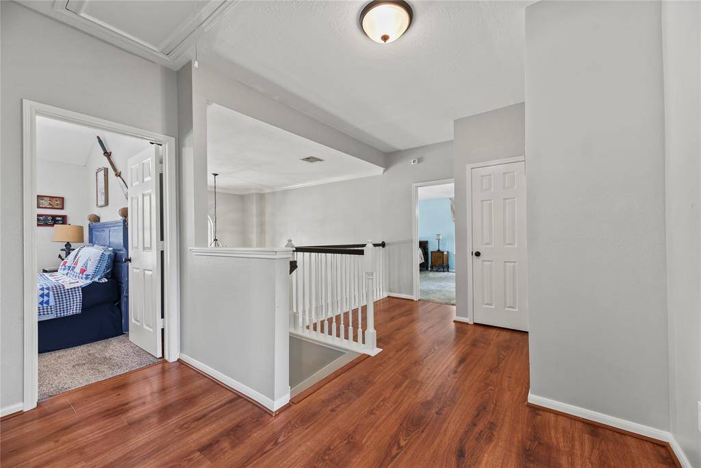 The upstairs landing offers easy access to all the bedrooms, creating a functional and connected layout. This central space adds a sense of openness while providing a smooth flow between rooms.