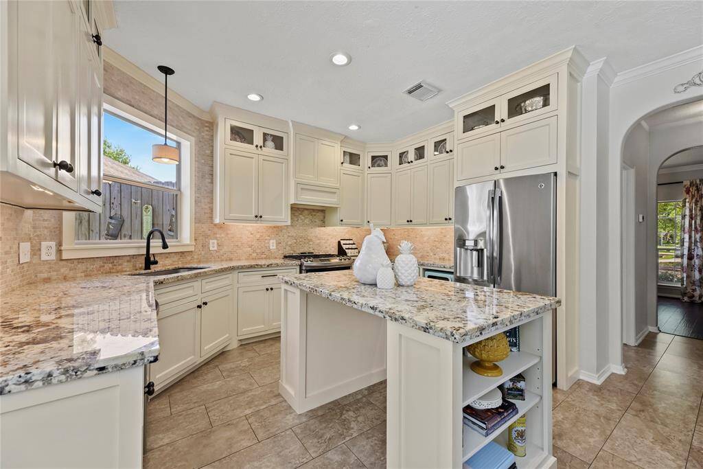 Boasting chic cabinets to the ceiling, there is an overflow of storage possibilities in the kitchen.