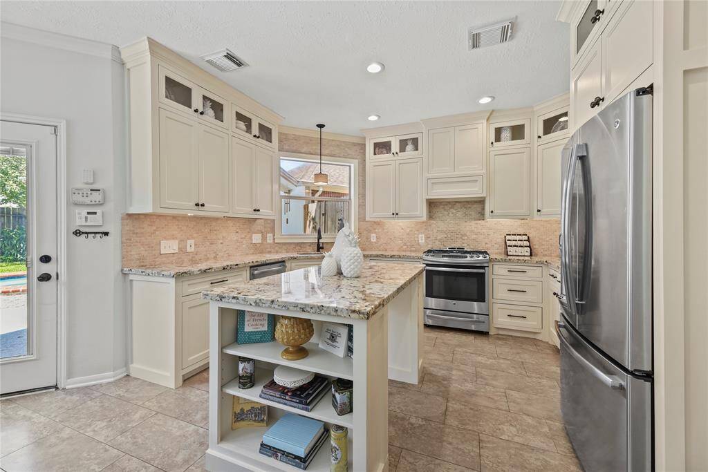 Imagine baking sugar cookies in the attractive and updated kitchen. Use the center island as a place to cut and decorate seasonal cookies with all sorts of sugar, sparkles, and candy!