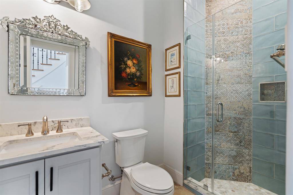Beautifully designed first-floor secondary bath features a rainfall showerhead.