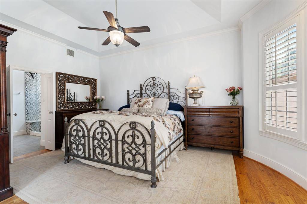 The primary bedroom overlooks the backyard pool and has access to the primary bath.