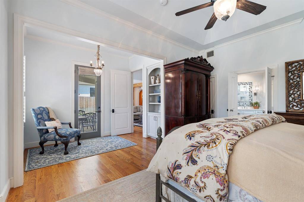 The primary bedroom sitting area has direct access to the backyard covered patio and family room.