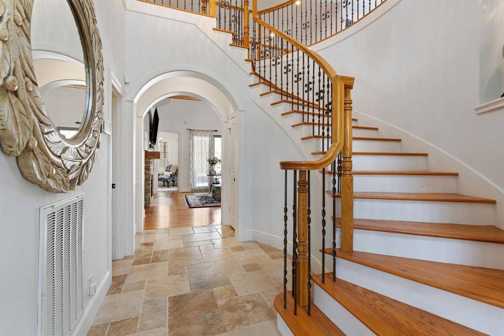 The entry staircase leads to the upstairs secondary bedrooms, game room, and loft.