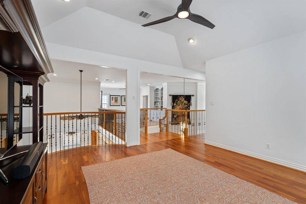 View of the game room towards the loft area that overlooks the family room below.