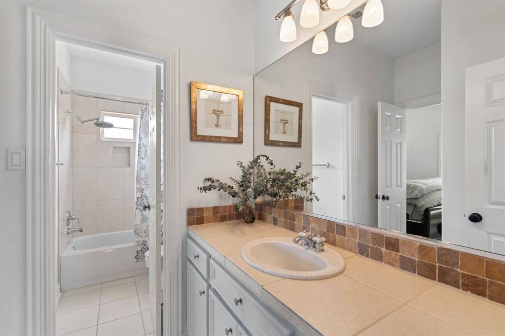 Secondary bath offers a tub/shower combo and plentiful cabinet storage.