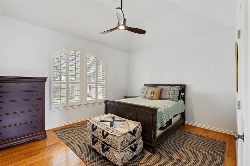 Secondary bedroom #2 features high ceilings, a large walk-in closet with built-in shelving, and access to "Jack & Jill" bath.