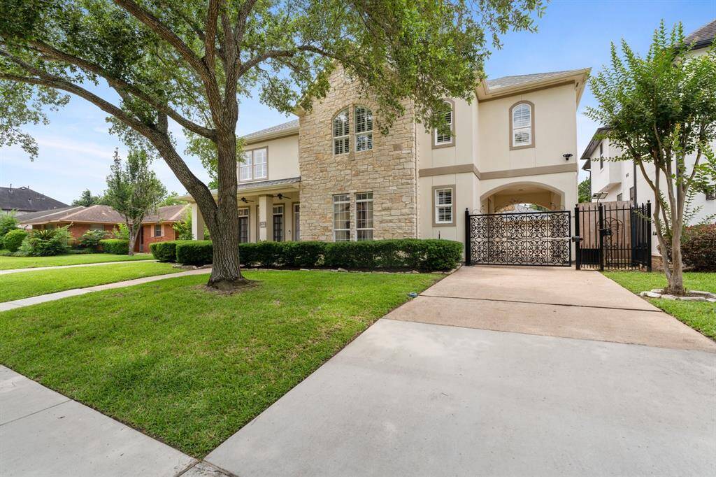 The home features a gated porte-cochere, long driveway, and 2-car garage.