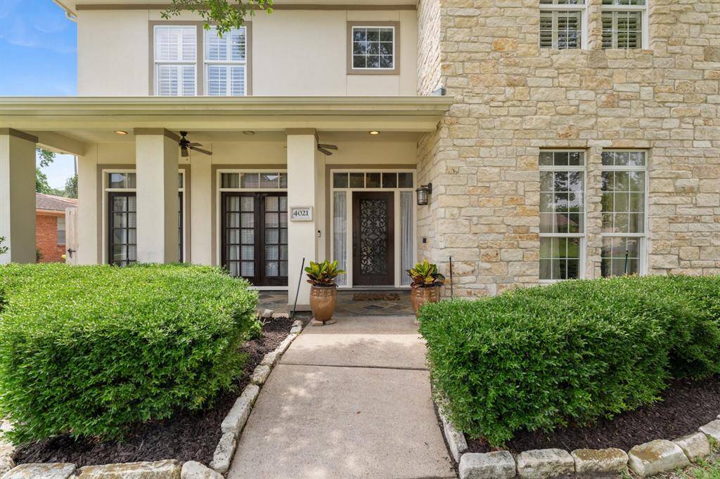 The walkway leads to a welcoming covered front patio.
