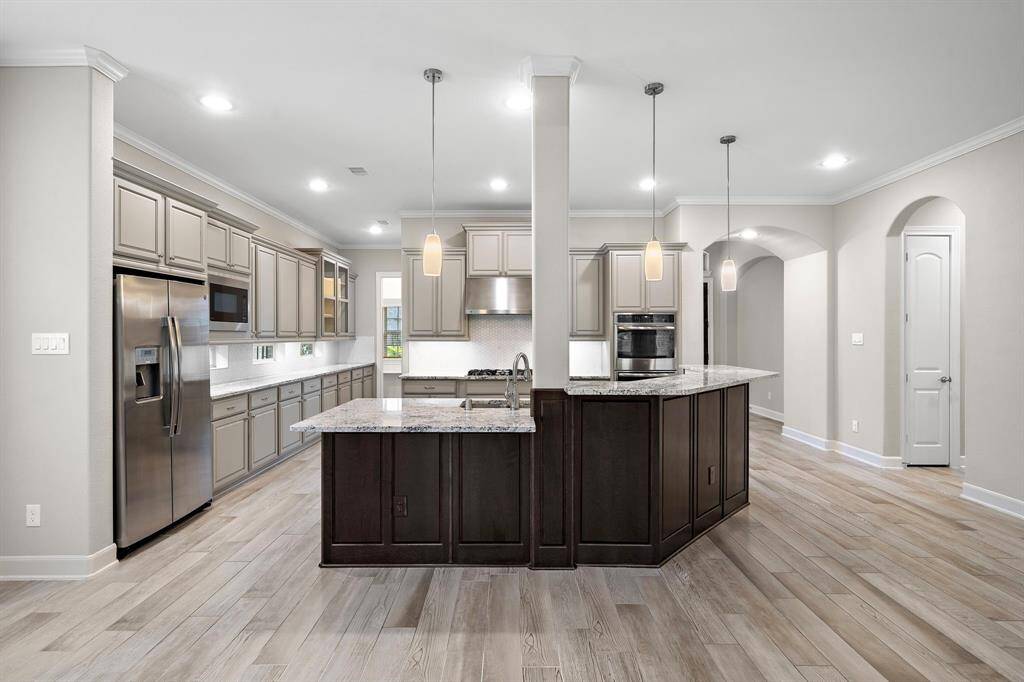 Gourmet kitchen has it all - extended counter and cabinet space,walk-in pantry, double ovens, a breakfast bar for extra seating, and includes the refrigerator.