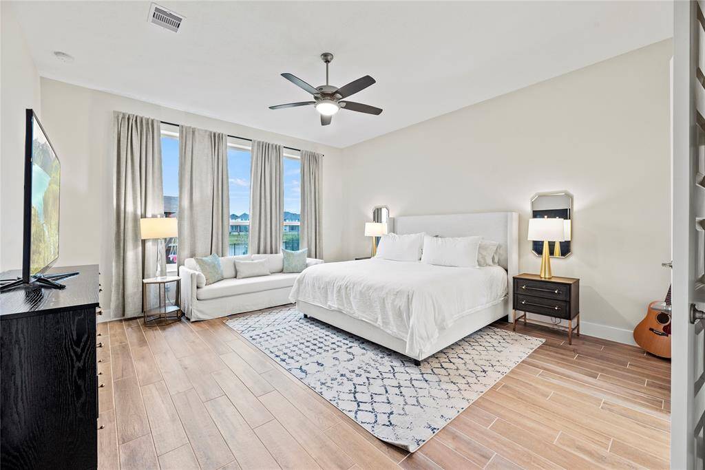 Spacious and bathed in natural light, with gorgeous wood-like tile planks, your primary retreat awaits, promising pure relaxation.
