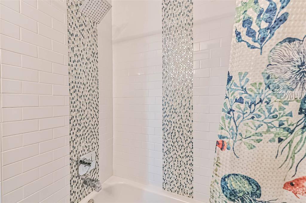 Subway and accent tile in tub/shower combo on main level