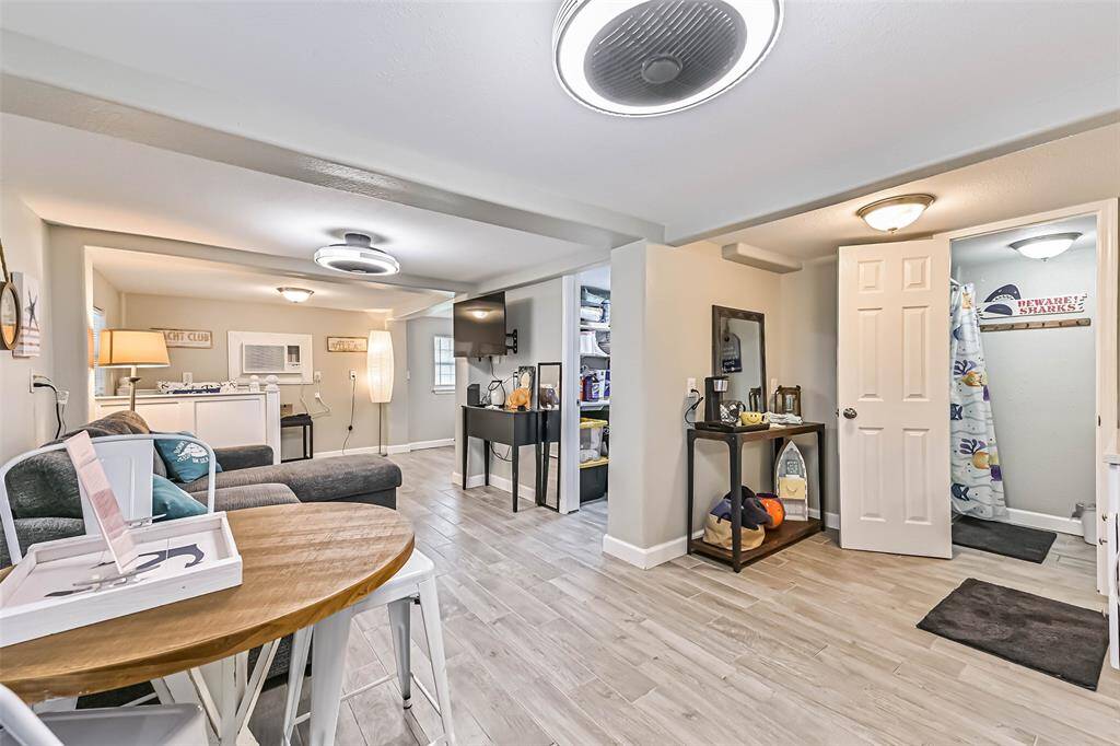 Ground level living and sleeping spaces with ceramic tile throughout, full restroom and inside laundry room with storage space