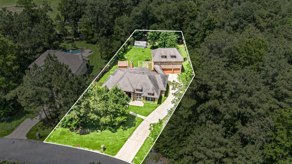 Oversized driveway and spacious three-car garage offer plenty of room for parking, storage, or weekend projects, perfect for multi-car households.