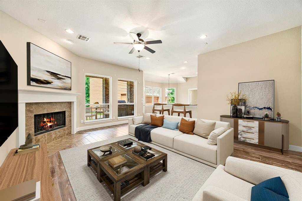 This light and bright spacious living room is the perfect layout for entertaining or just relaxing. Whether it's simply a night in or entertaining family and friends, this home has ample open space for everyone to enjoy! Featuring dark stained ceiling fan, large tile flooring, large windows with blinds, soaring high ceilings, recessed lighting with wonderful access to your gorgeous kitchen. *Virtually Staged