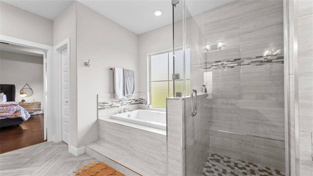 Whether you are ready for a relaxing soak in the tub or a steamy shower the luxurious primary bathroom will more than meet your needs.