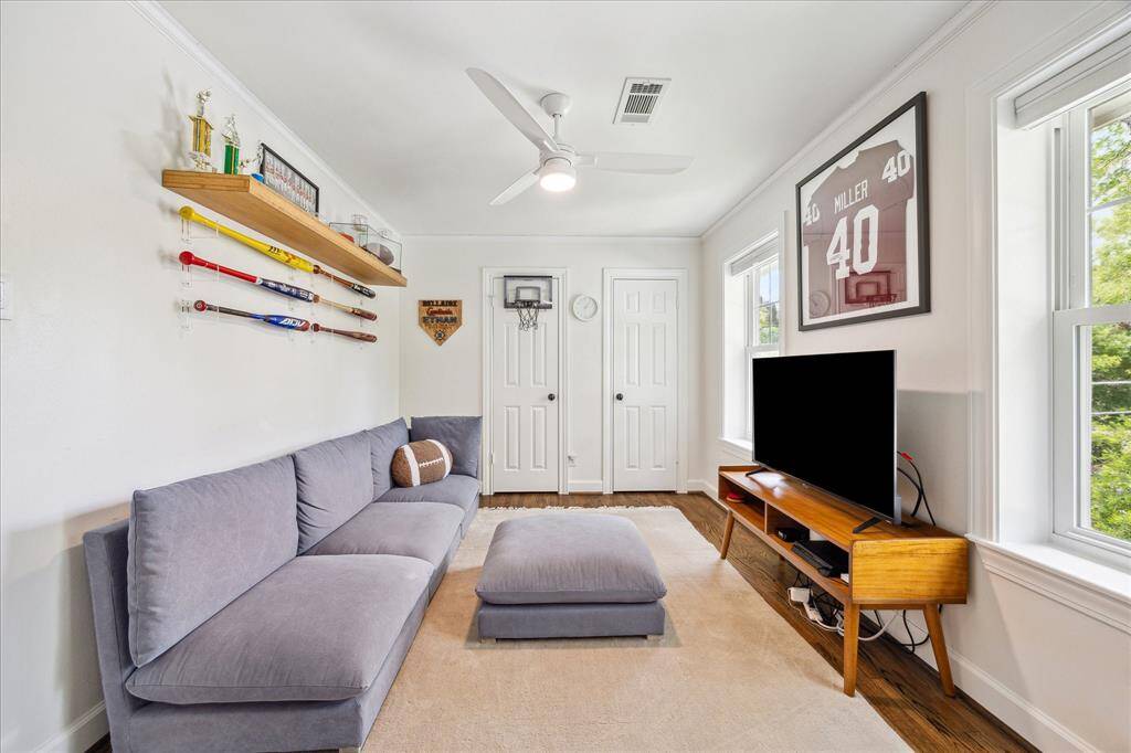 This bright and versatile game room offers the perfect retreat with rich hardwood floors, ample natural light, and stylish finishes—ideal for lounging, play, or media enjoyment.