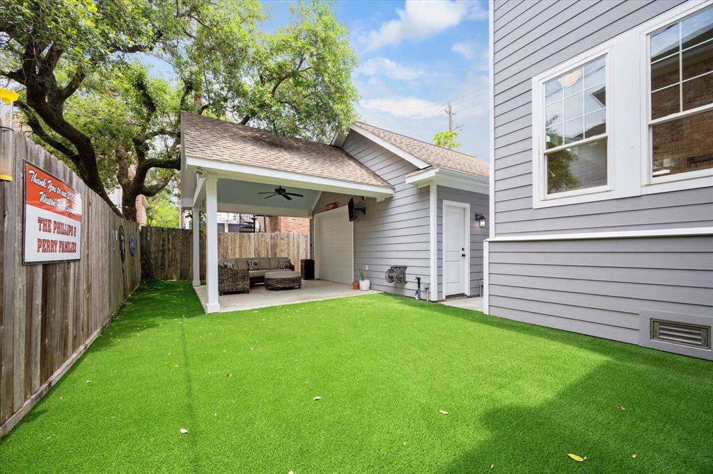 This beautifully maintained backyard offers a seamless blend of comfort and function with lush turf, a charming covered lounge area, and easy access to the garage and main home.