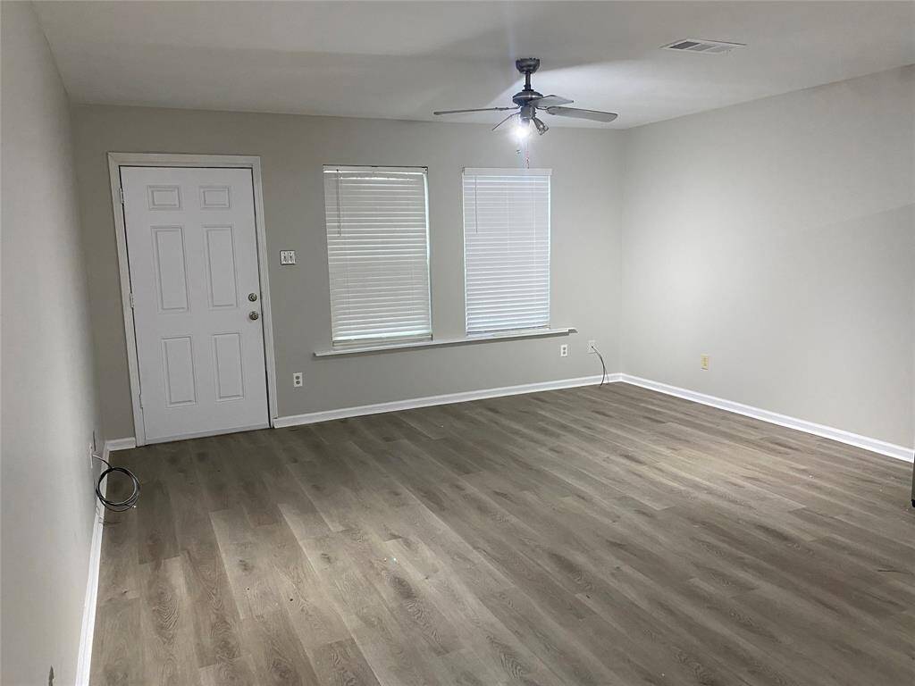 As you enter the side door of the home along the driveway, you will see the living room to your left and front door access.
