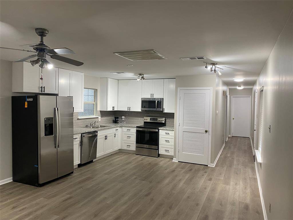 As you enter the front door of the home you will see the open floor plan of the living room and kitchen. The hallway will take you to the bedrooms and bathroom. Your stackable washer and dryer will be tucked away in the laundry closet as seen to the left of the hallway.