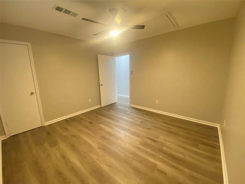 On the other side of the room you will see the closet door which is a walk-in closet.