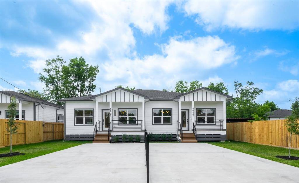 Modern duplex with a clean white exterior and black trim
