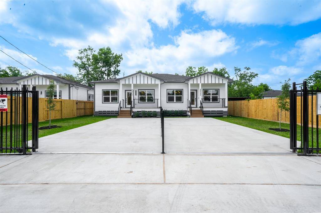 Spacious driveway, gated entry, and a neatly manicured lawn