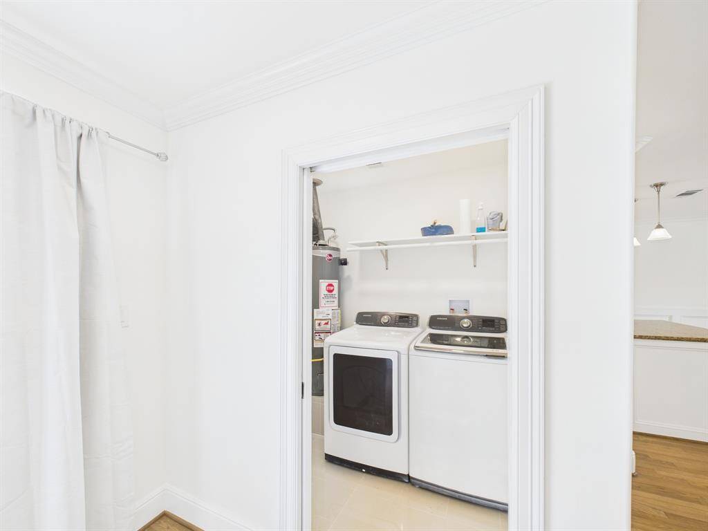Laundry room with washer and dryer included, and shelving for storage.