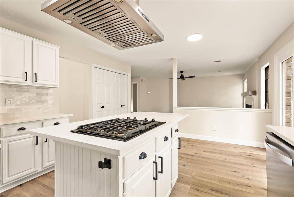 The heart of the home—this kitchen offers a stainless gas cooktop, tiled backsplash, updated hardware and plenty of storage!