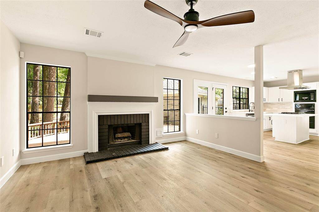 The family room is highlighted by a gas log fireplace, floating mantle and views of the freshly landscaped backyard.