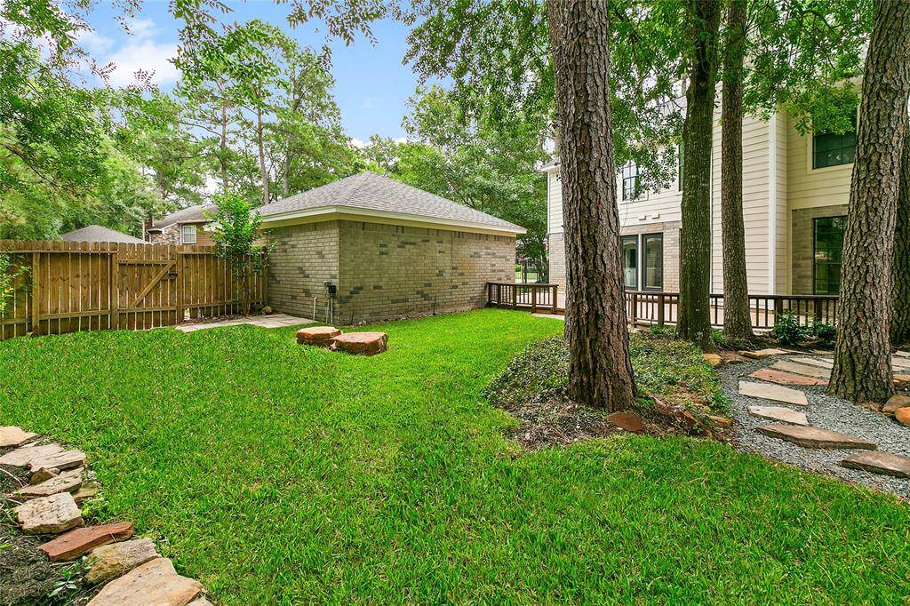 Lovely backyard features a lush lawn shaded by mature trees. A detached 2-car brick garage provides secure parking and additional space.