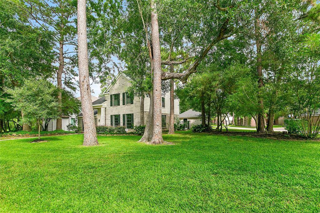 Another look at the beautifully maintained front yard positioned on a quiet, tree-lined street.