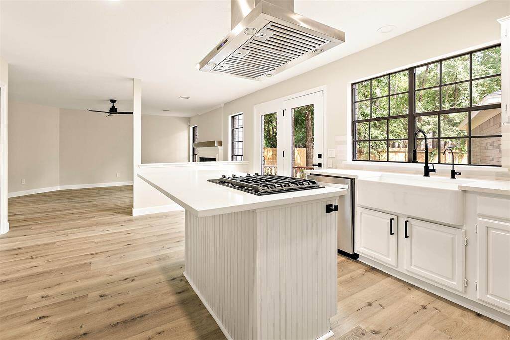 Large center island with bar seating and quartz countertops—ideal for meal prep, casual dining, or morning coffee.