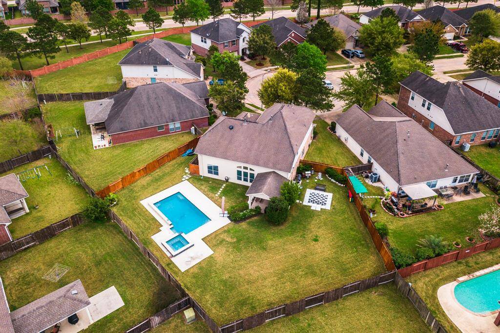 Another shot of the large oversized cul-de-sac lot.  This yard has a covered patio, pool, and plenty of room for play.