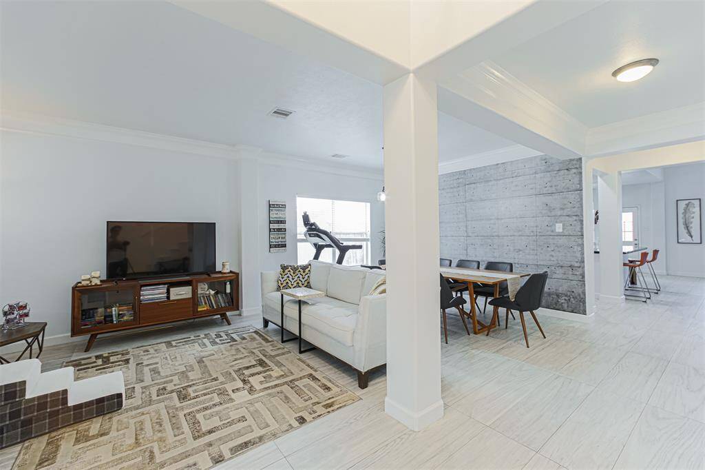 Bright open floor plan with neutral gray and white color scheme.