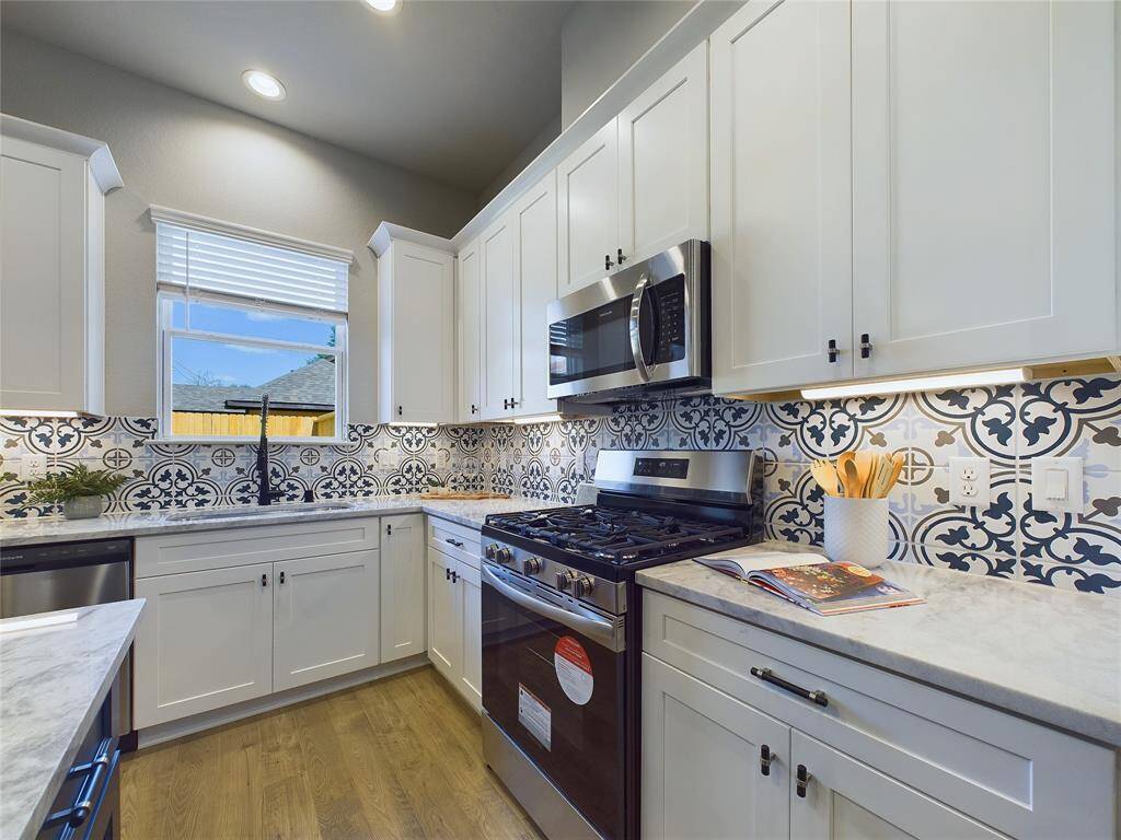 kitchen with stainless steel appliances (staged model home)