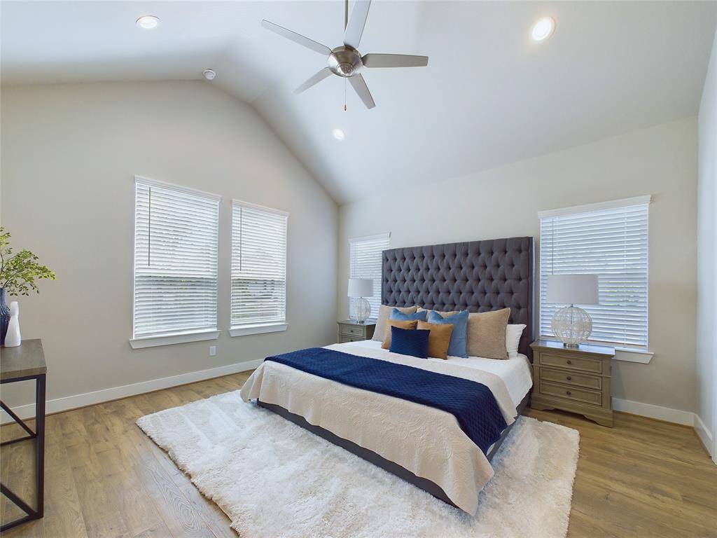 Primary bedroom with vaulted ceilings