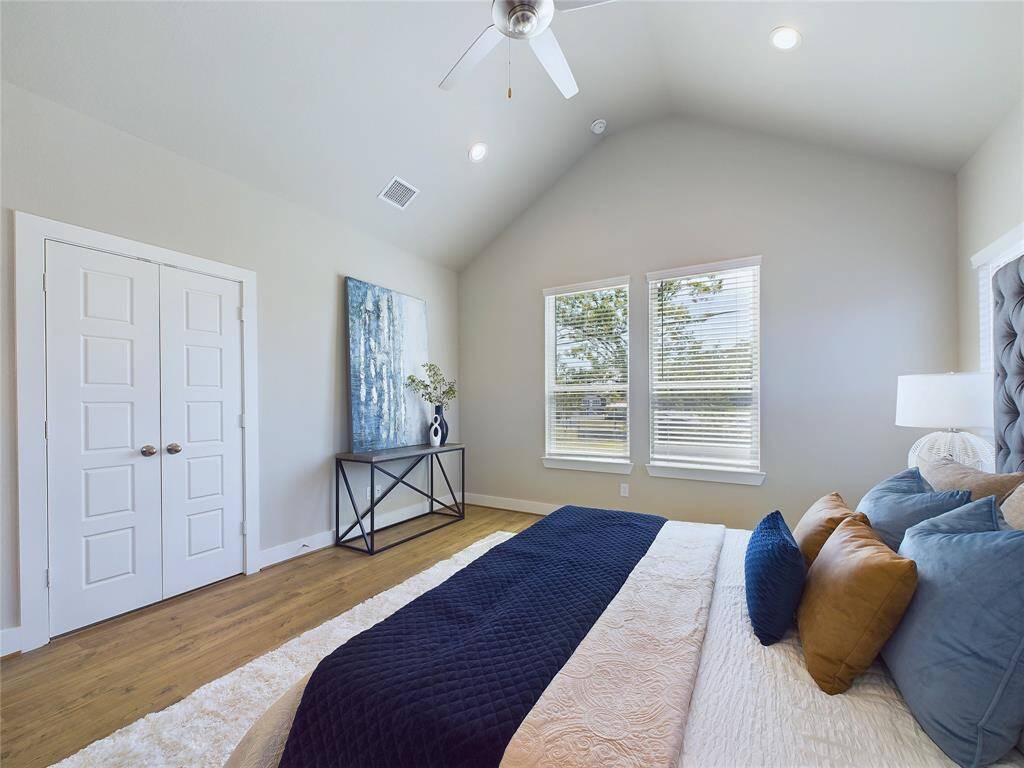 Primary bedroom with vaulted ceilings