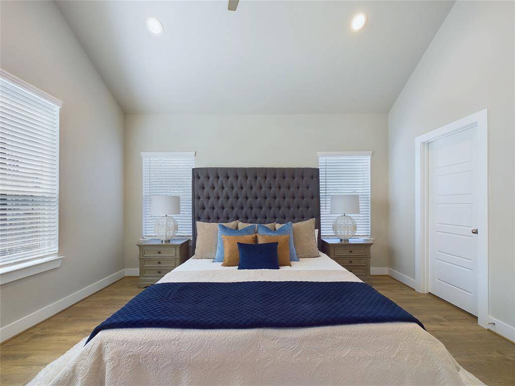 Primary bedroom with vaulted ceilings