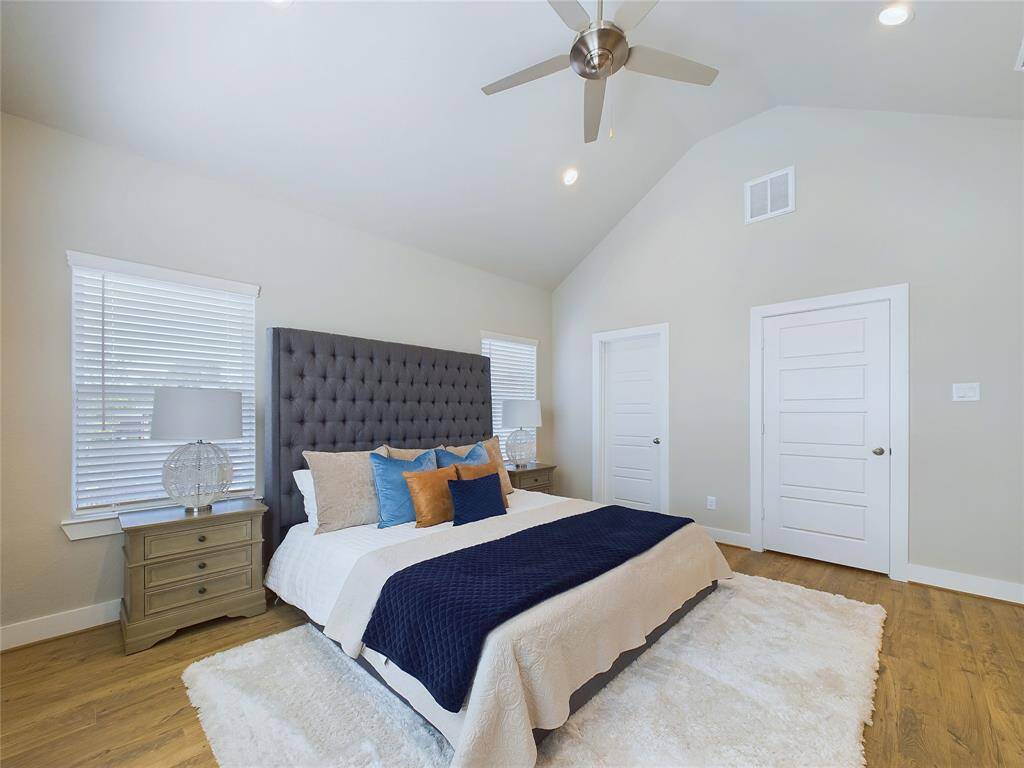 Primary bedroom with vaulted ceilings