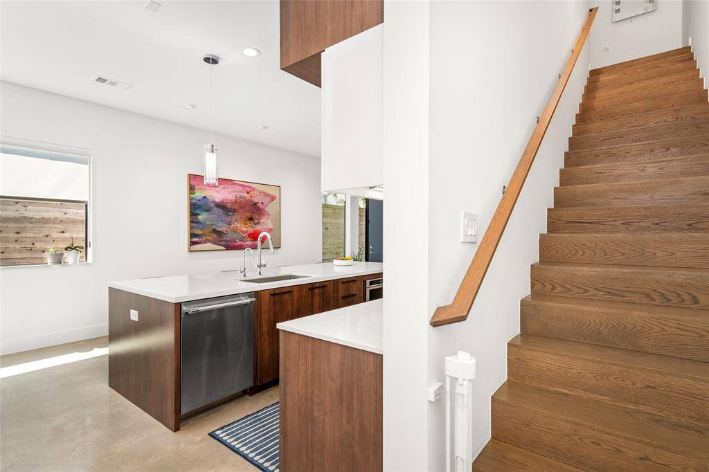 The vanity area is thoughtfully positioned between the bathroom and the closet.