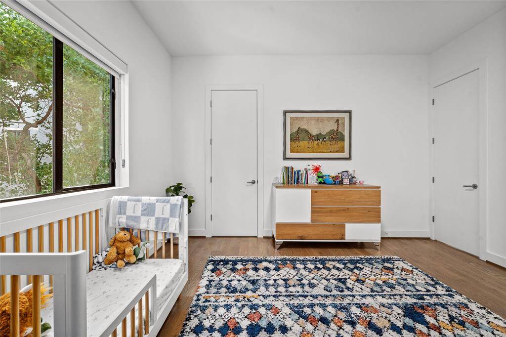 The secondary bedroom, also situated on the second floor, features a walk-in closet and direct access to one of the secondary bathrooms.
